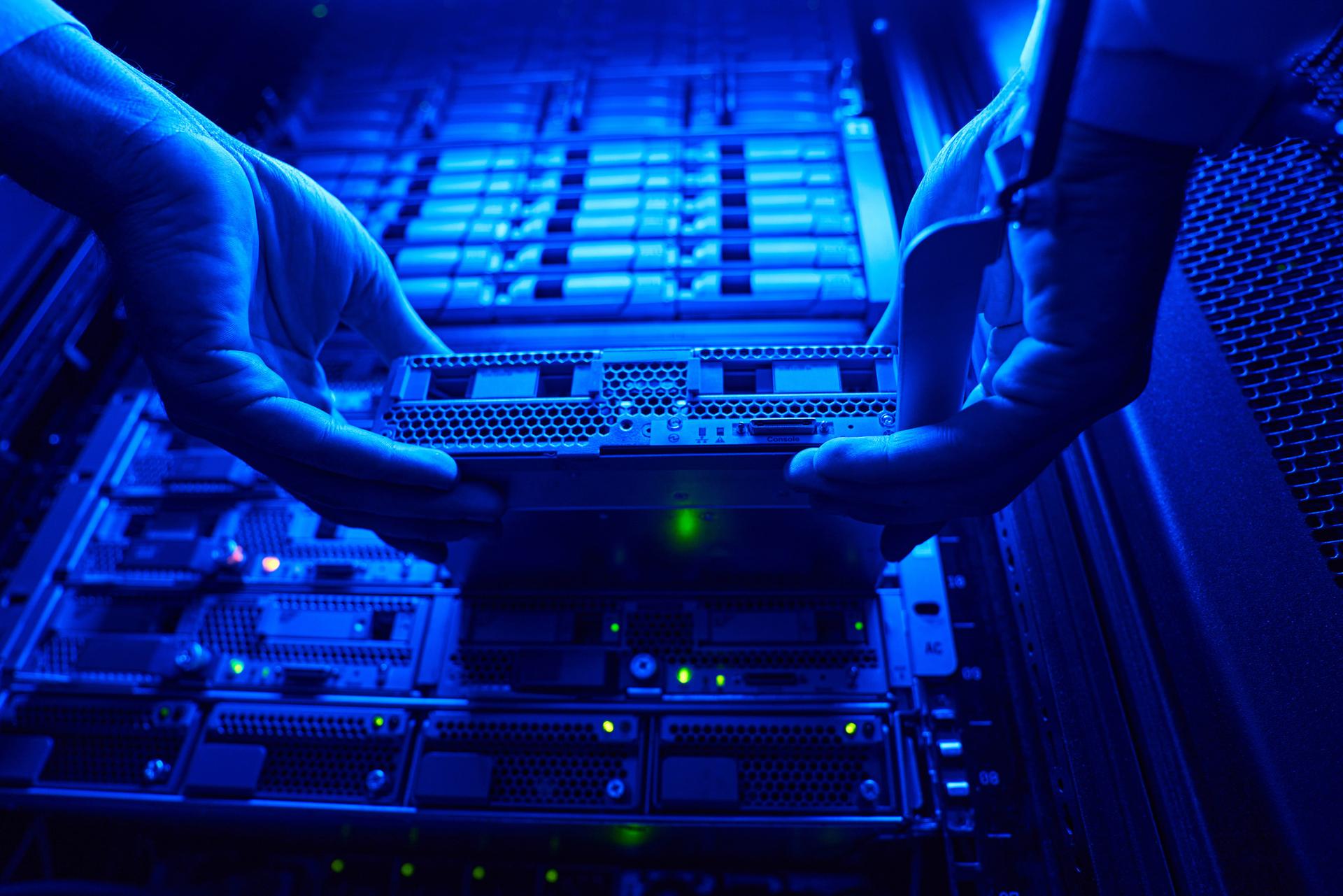 Engineers building and securing a server